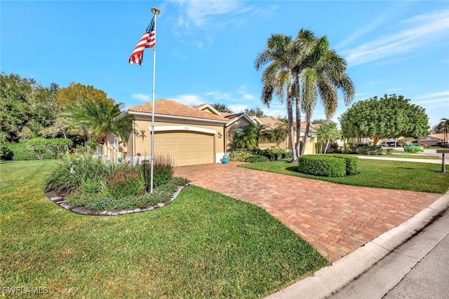 view of front facade with a garage and a front lawn