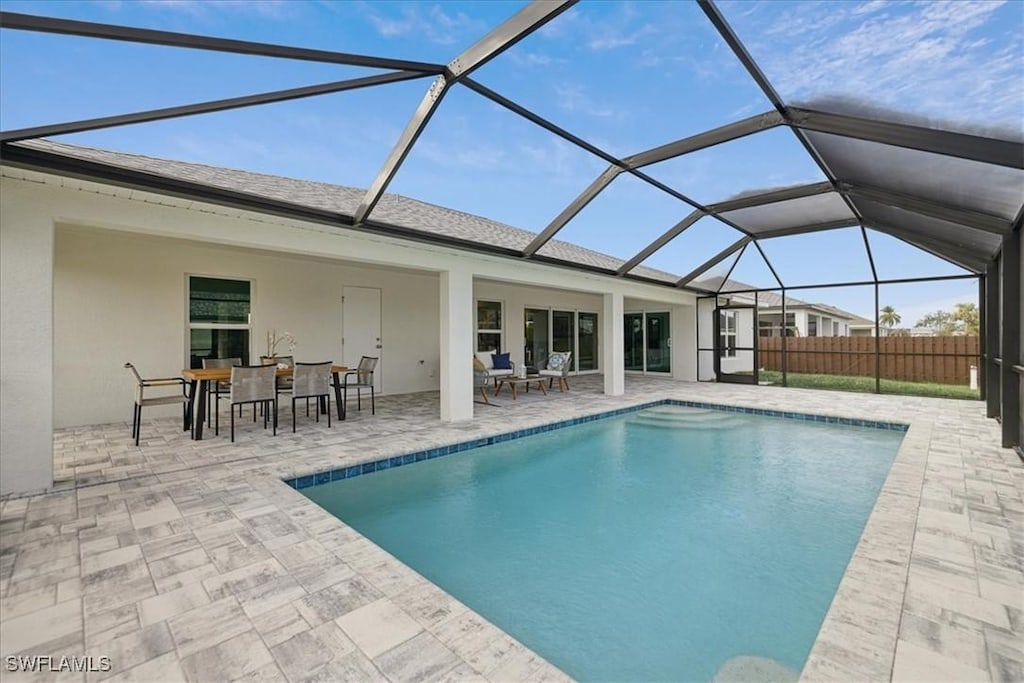 view of swimming pool with a lanai and a patio area