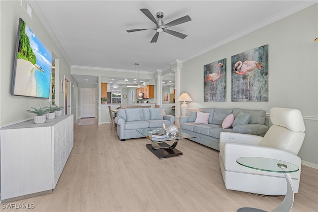 living room featuring crown molding, ceiling fan, and light wood-type flooring