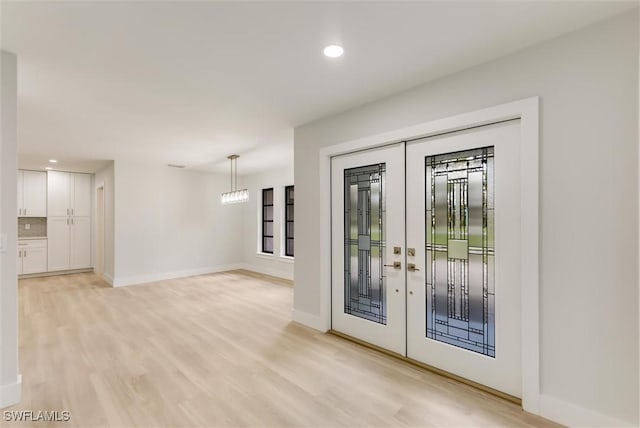 doorway to outside with light wood-type flooring and french doors