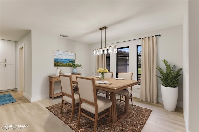 dining space with light wood-type flooring