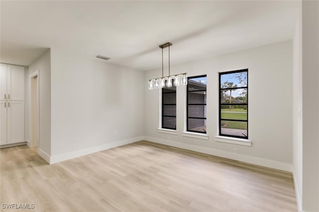 unfurnished dining area featuring light wood-type flooring