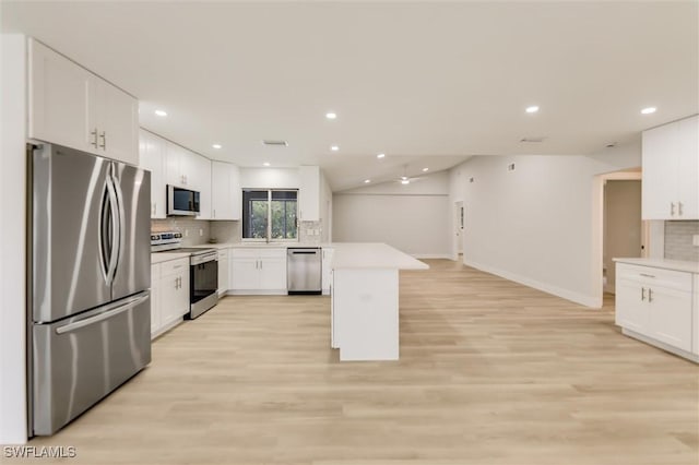 kitchen featuring sink, light hardwood / wood-style flooring, white cabinetry, backsplash, and stainless steel appliances