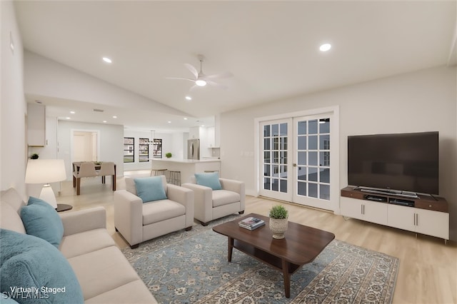 living room with french doors, ceiling fan, light hardwood / wood-style floors, and vaulted ceiling