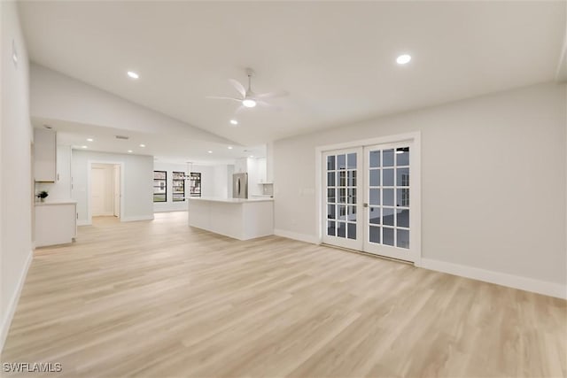 unfurnished living room featuring french doors, ceiling fan, lofted ceiling, and light hardwood / wood-style flooring