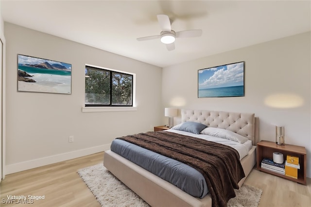 bedroom with ceiling fan and light wood-type flooring