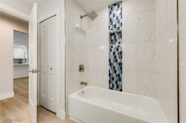 bathroom featuring hardwood / wood-style flooring and tiled shower / bath combo