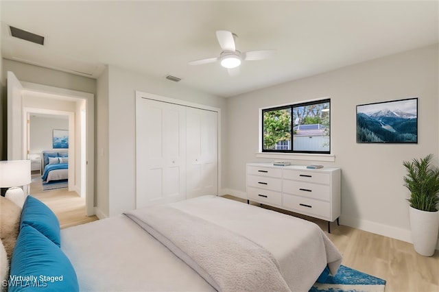 bedroom featuring a closet, ceiling fan, and light hardwood / wood-style flooring