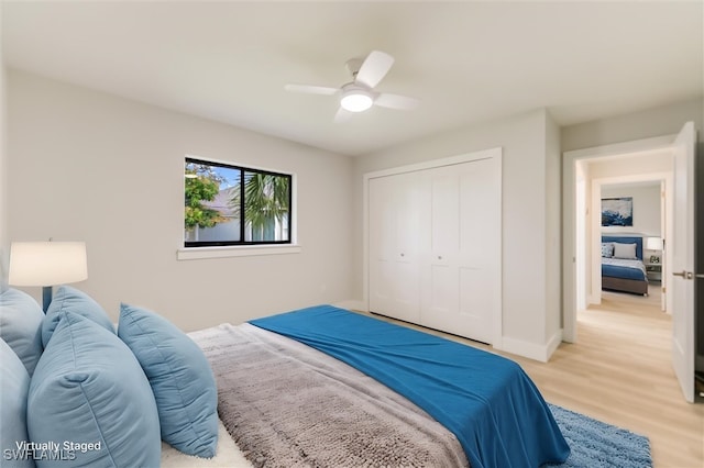 bedroom featuring a closet, ceiling fan, and light hardwood / wood-style flooring