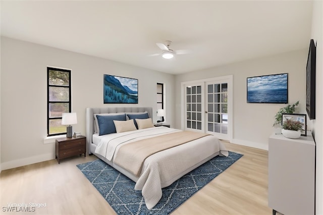 bedroom with hardwood / wood-style floors, french doors, and ceiling fan