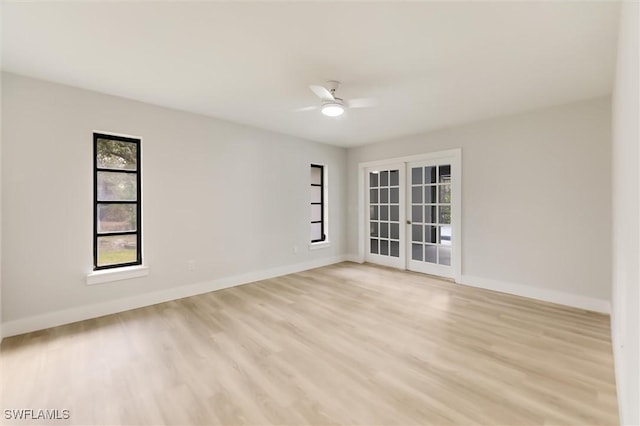 unfurnished room featuring light hardwood / wood-style floors, french doors, and ceiling fan