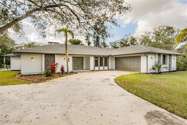 single story home with a garage and a front lawn