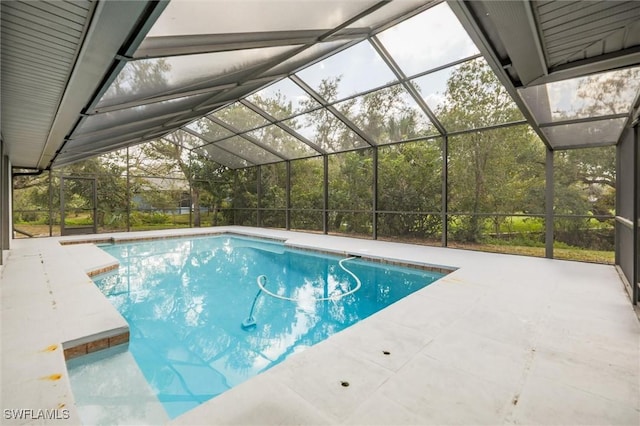 view of swimming pool featuring a lanai and a patio