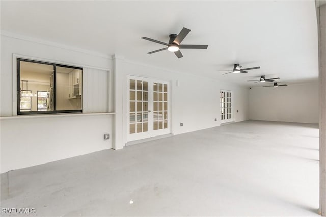 unfurnished living room with french doors, ceiling fan, and concrete flooring