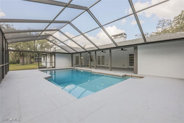 view of pool featuring french doors, ceiling fan, a lanai, and a patio