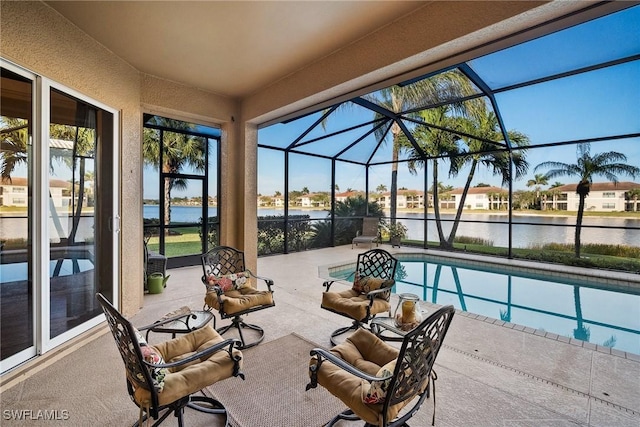 view of pool with a water view, a lanai, and a patio area