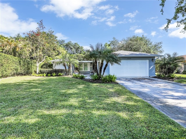 ranch-style home with a garage and a front lawn