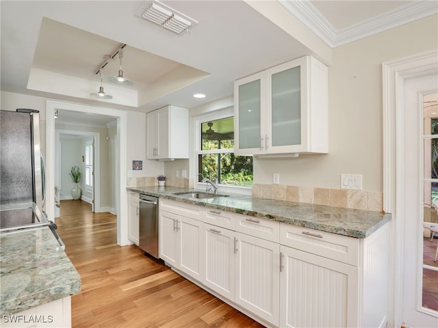 kitchen featuring stainless steel appliances, white cabinetry, a raised ceiling, and sink