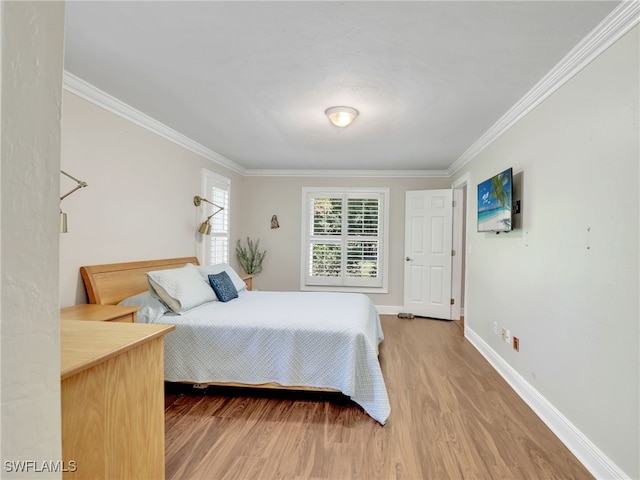 bedroom with hardwood / wood-style flooring and crown molding