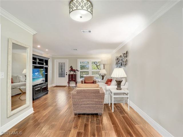 sitting room featuring dark hardwood / wood-style flooring and ornamental molding