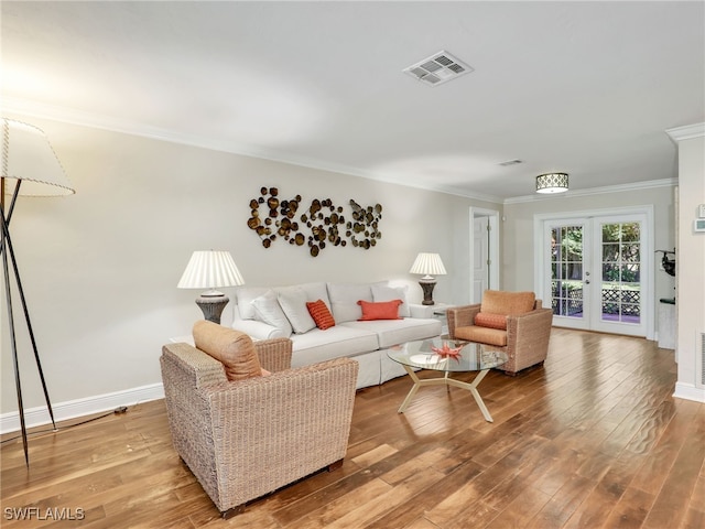 living room with french doors, ornamental molding, and hardwood / wood-style flooring