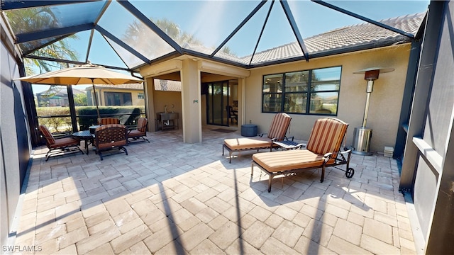 view of patio featuring glass enclosure