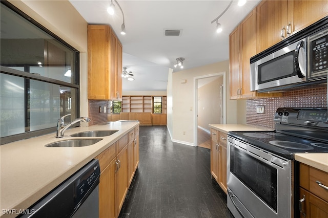 kitchen featuring dark hardwood / wood-style flooring, sink, decorative backsplash, and stainless steel appliances