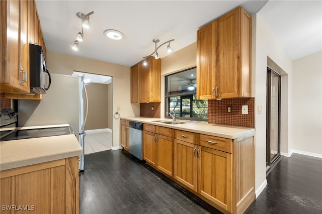 kitchen with sink, tasteful backsplash, stainless steel dishwasher, dark hardwood / wood-style flooring, and ceiling fan