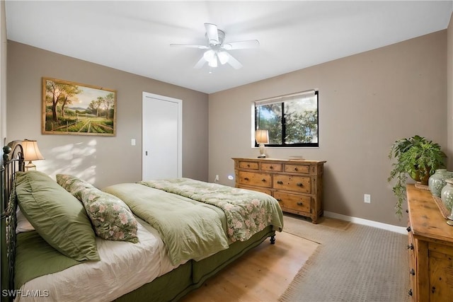 bedroom featuring light carpet and ceiling fan