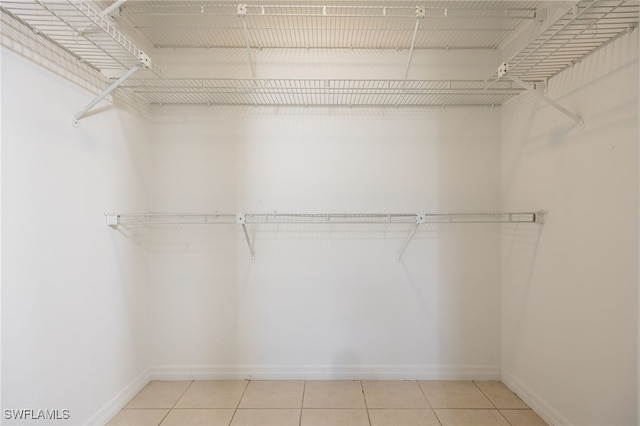 spacious closet with tile patterned floors