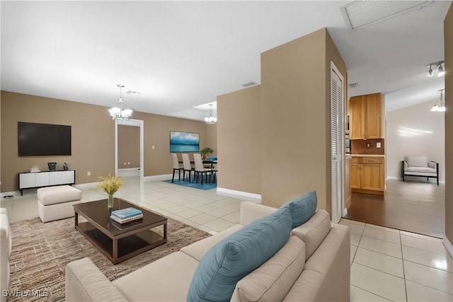 living room featuring light tile patterned flooring and a chandelier