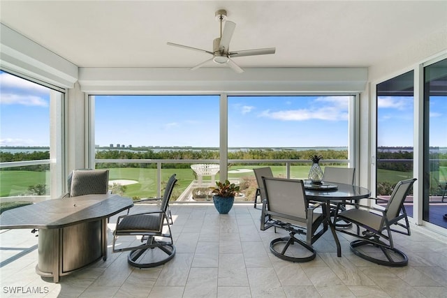 sunroom featuring ceiling fan