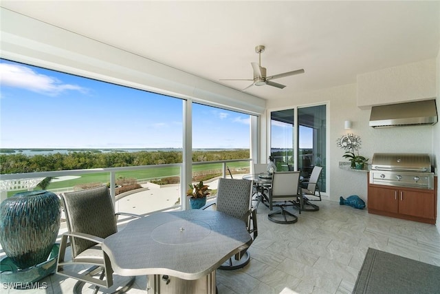 sunroom featuring ceiling fan