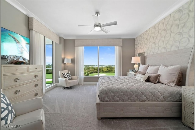 carpeted bedroom featuring ceiling fan and ornamental molding