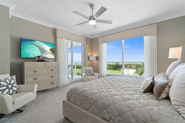 bedroom featuring ornamental molding, light colored carpet, and ceiling fan