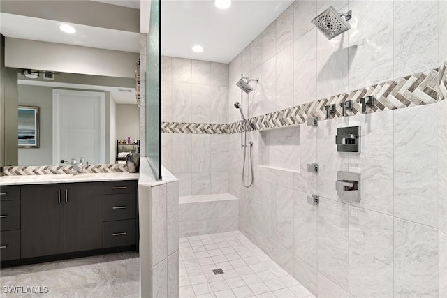 bathroom with vanity and tiled shower