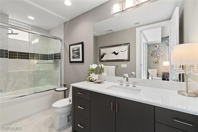 full bathroom with vanity, combined bath / shower with glass door, tile patterned floors, and toilet