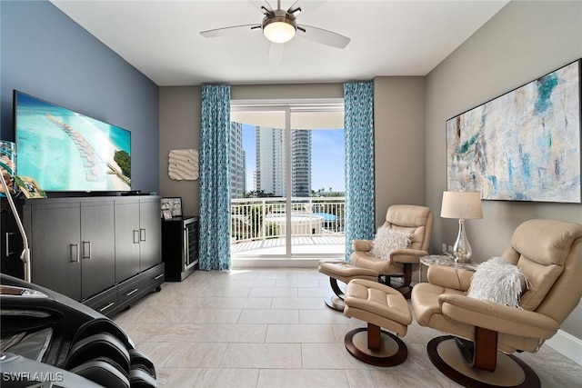 living area featuring light tile patterned floors and ceiling fan