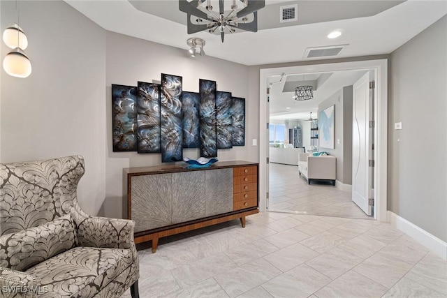 hall with an inviting chandelier