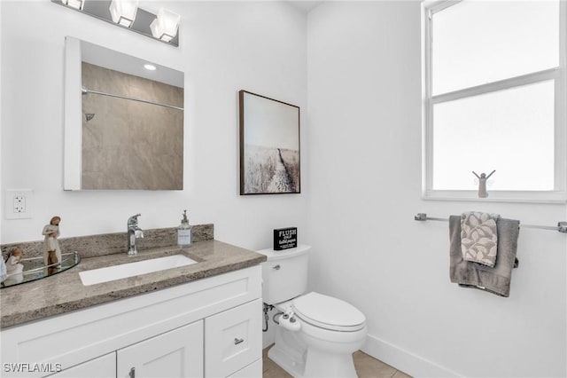 bathroom featuring vanity, toilet, and a shower