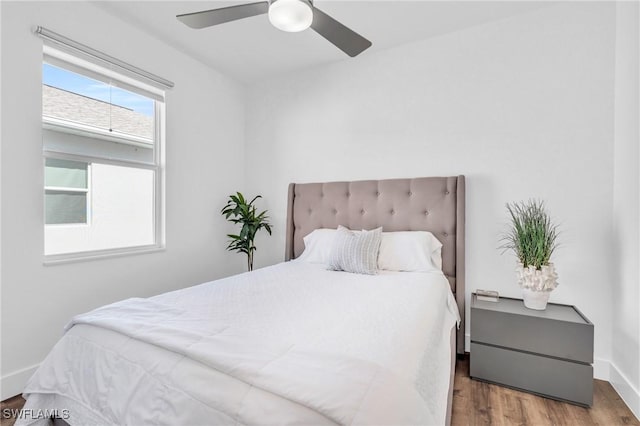 bedroom featuring ceiling fan and dark hardwood / wood-style flooring