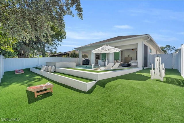 back of house featuring a yard, a swimming pool, and a patio area