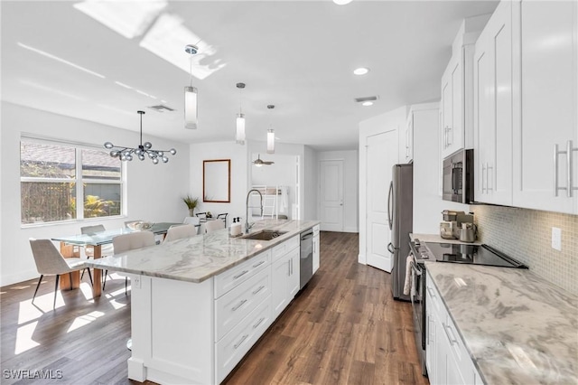 kitchen featuring white cabinetry, an island with sink, appliances with stainless steel finishes, and sink