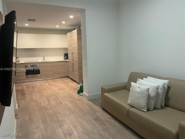 interior space with sink and light hardwood / wood-style flooring