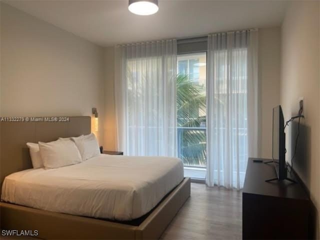 bedroom featuring hardwood / wood-style floors and access to exterior