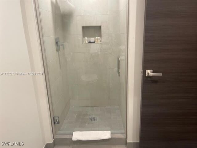 bathroom with a shower with door