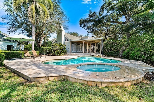 view of swimming pool featuring pool water feature, a patio, and an in ground hot tub