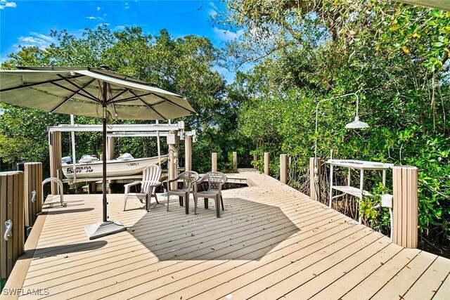 216 Cocohatchee Blvd, Naples, FL 34110 - wooden deck with a dock and boat lift