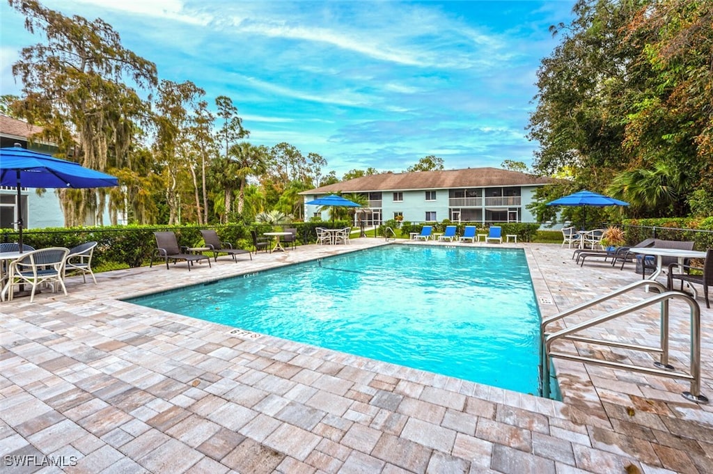 view of swimming pool with a patio area