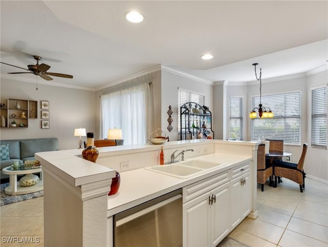 kitchen featuring pendant lighting, sink, dishwasher, white cabinetry, and an island with sink